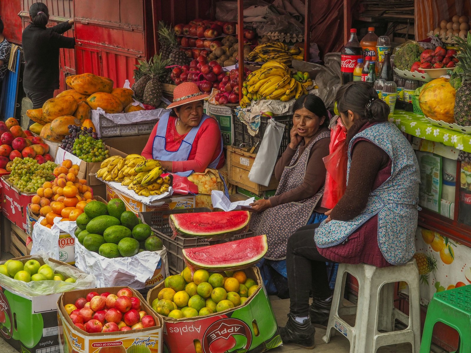 Women selling tropical fruit at a vibrant street market in Bolivia