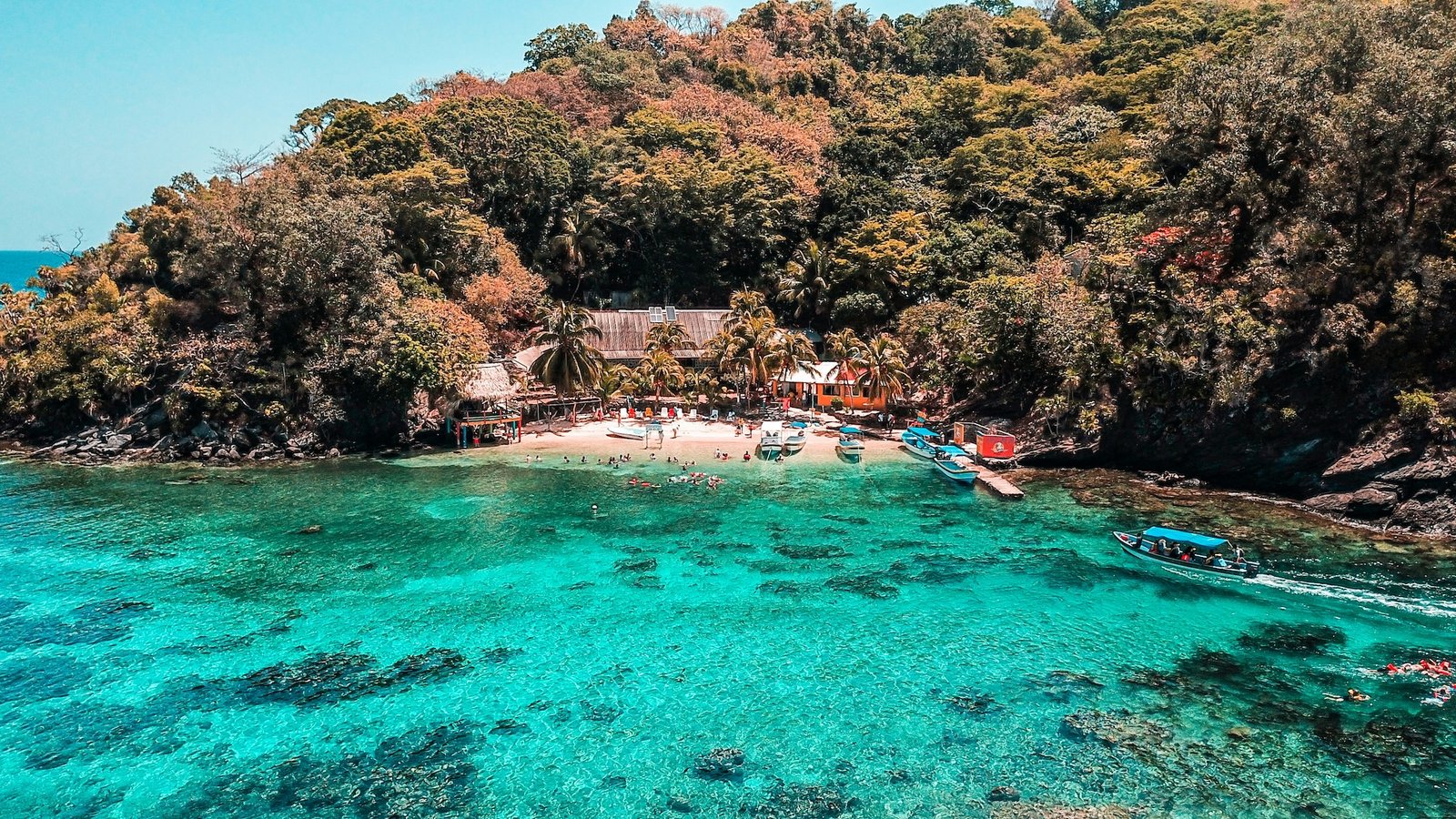 Aerial view of a secluded cove with crystal-clear turquoise water on Roatán, Bay Islands, Honduras