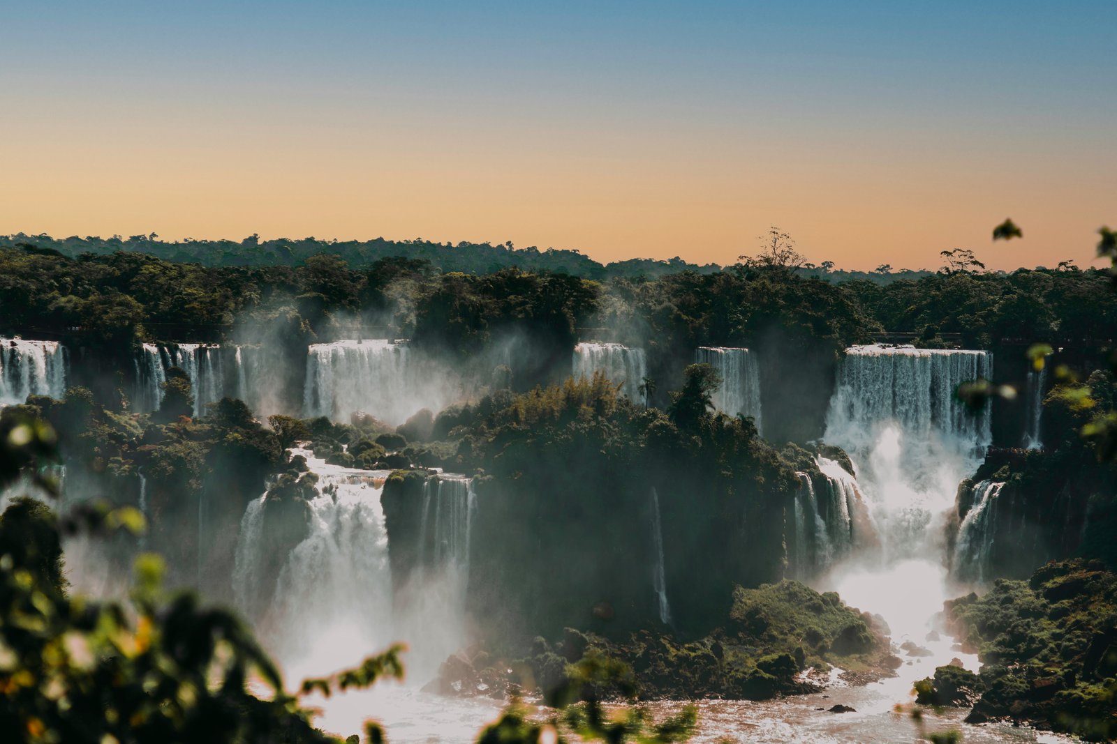 Iguazú Falls cascading through rainforest at golden hour, Paraguay